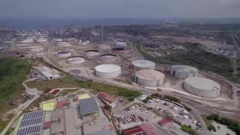 Aerial-dolly-shot-of-an-empty-fuel-storage-facility-in-Catania,-Sicily,-Italy