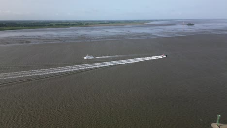 Two-boats-cross-each-other-on-the-sea,-Bremerhaven,-germany,-europe,-drone,-north-sea