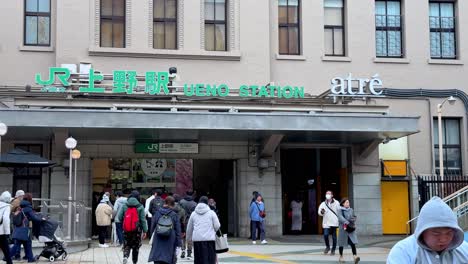 Busy-Ueno-Station-entrance-in-Tokyo-with-pedestrians-during-daytime,-wide-shot