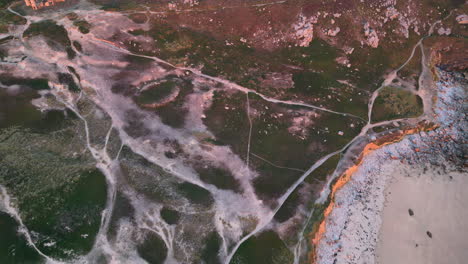 Aerial-View-of-Rocky-Area-and-Pathways-on-a-Coastline