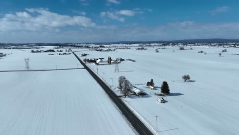 Panoramic-aerial-of-snow-covered-farmland-in-USA