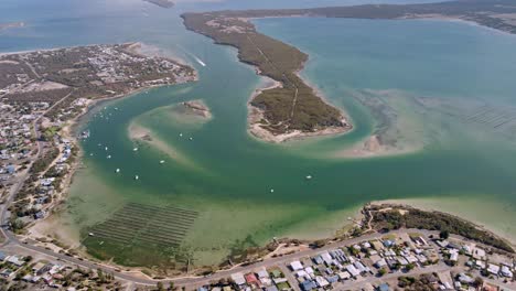 Holiday-destination-of-Coffin-Bay-aerial-with-waterfront-houses-and-turquoise-ocean-inlet,-Eyre-Peninsula,-South-Australia