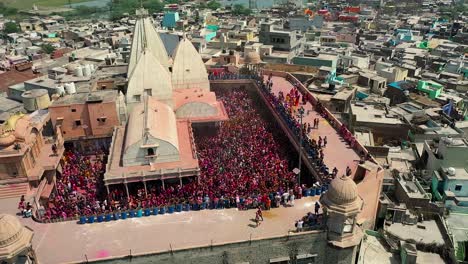 Aerial-drone-view-where-a-lot-of-people-squat-is-playing-and-many-houses-are-appearing-around