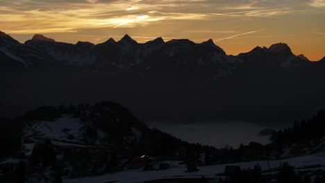 Twilight-hues-over-Amden,-Weesen,-with-silhouetted-Glarus-Alps-in-Schweiz,-calm-and-serene