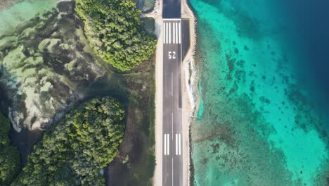 An-airstrip-on-great-roque,-los-roques-with-clear-turquoise-waters,-aerial-view