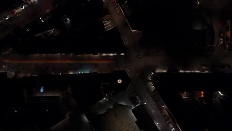 Downtown-Reykjavik-with-famous-rainbow-street-at-night,-drone-shot