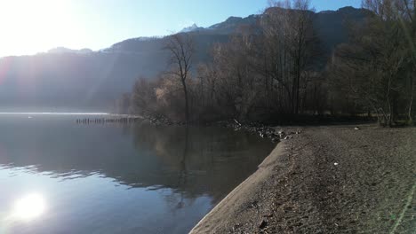 Drifting-gracefully-above-the-sunlit-shores-of-Lake-Walensee-in-Switzerland,-embodying-the-essence-of-leisure-in-nature,-travel,-and-vacation