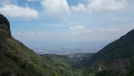 Beautiful-Shot-of-Drone-Approaching-Valley-with-Costa-Rican-Capitol-Seen-in-Distance