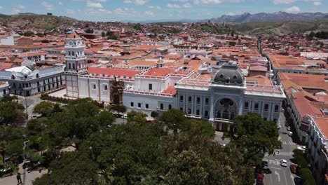 Aerial-flyover:-City-Main-Square-toward-Basilica-in-Sucre,-Bolivia