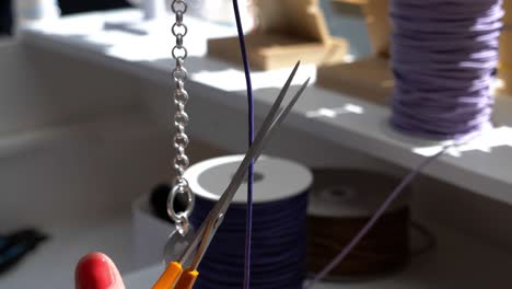 Slow-motion-shot-of-a-worker-measuring-rope-the-length-as-the-bracelet