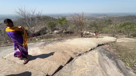 Woman-climbing-mountain-in-Maa-Kauleshwari-Temple,-Chatra-in-Jharkhand