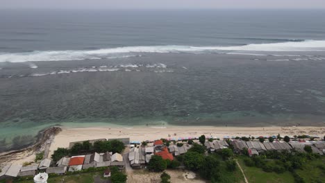 Aerial-view,-Bali's-Pandawa-coastline,-which-is-a-popular-beach-on-the-Indonesian-island-of-Bali-with-its-distinctive-limestone