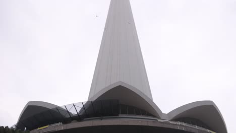 looking-up-at-KL-Tower-telecommunications-from-the-ground-level-in-Kuala-Lumpur,-Malaysia