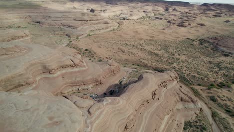 A-spectacular-and-high-flying-4K-drone-shot-over-the-rugged,-desert-like-terrain-and-unique-rock-formations-of-Whitewash-Sand-Dunes,-a-recreation-area-near-Green-River-and-Moab,-Utah