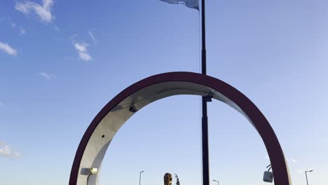 Close-up-view-of-flag-of-Argentina-and-Statue-of-General-Martin-Miguel-de-Guemes-at-Plaza-Gendarmeria-Nacional-in-Ushuaia