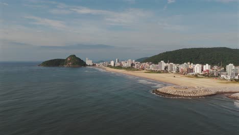 A-panoramic-aerial-image-of-Matinhos,-capturing-the-scenic-beauty-of-this-coastal-town-nestled-along-the-shores-of-Paraná,-Brazil