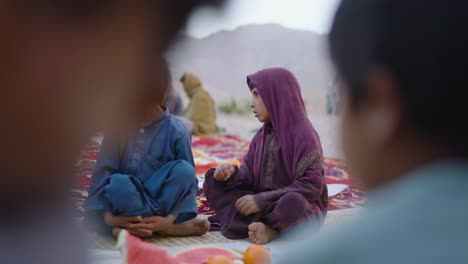 Small-Pakistani-boys-waiting-for-their-Ramadan-iftar-in-Khuzdar,-Balochistan,-Pakistan