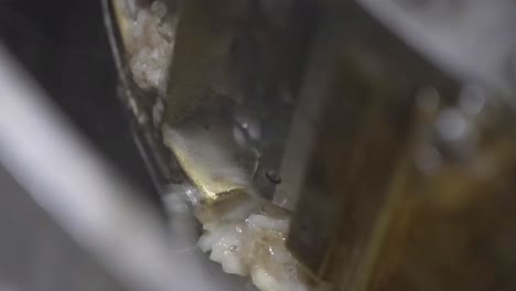 Close-up-a-machine-slices-potatoes-automatically