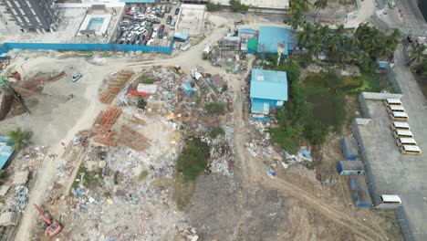 Aerial-video-of-a-salvage-yard-crammed-with-vehicles,-real-estate,-steel-and-cement-blocks