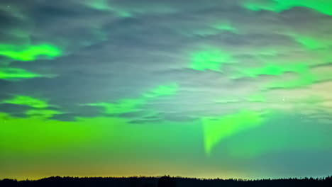 Beautiful-shot-of-the-Northern-Lights-in-a-clear-sky-with-few-clouds-and-shooting-stars-in-the-sky