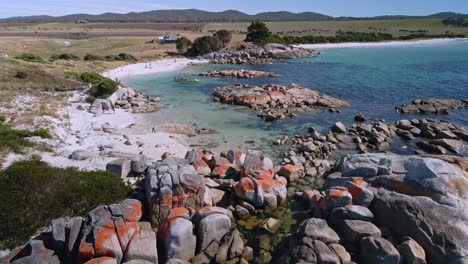 Stunning-Bay-of-Fires-aerial-with-granite-boulders,-white-sand-beach-and-clear-water-in-Tasmania,-Australia