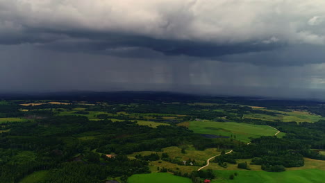 Rain-storm-over-countryside-landscape-in-Europe,-aerial-drone-view