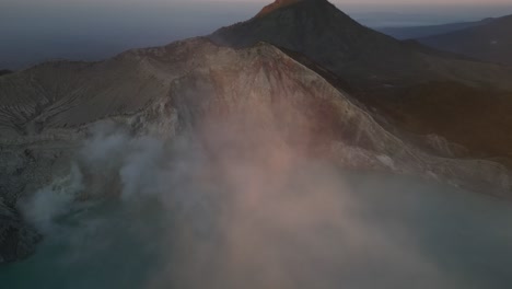 Morning-drone-footage-captures-volcanic-activity-and-smoke-with-a-beautiful-sunrise-light