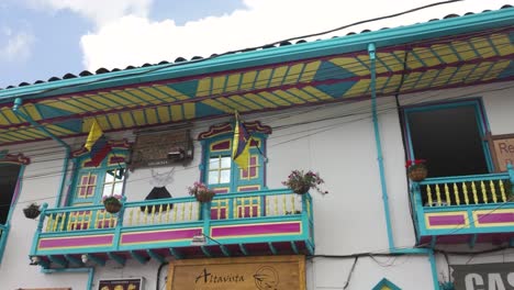 Looking-Up-At-Colourful-Turquoise-Colonial-Style-Wooden-Balconies-in-Filandia-Colombia