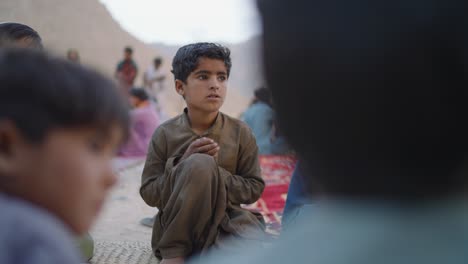 Child-Seen-Praying-before-having-iftar-dinner-together-during-ramadan-in-Khuzdar,-Balochistan