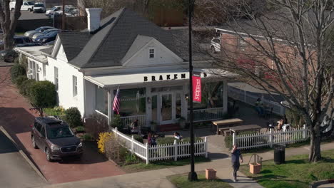 Slow-motion-truck-left-of-people-relaxing-in-front-of-Brakeman's-Coffee-Supply