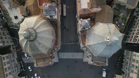 Top-Down-Aerial-View-Above-Domes-of-Two-Twin-Churches---Piazza-del-Popolo,-Rome,-Italy