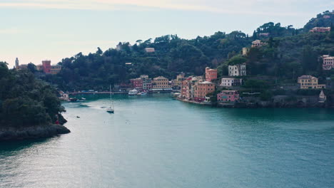Wide-aerial-view-of-entrance-to-Portofino-seaside-village-harbor,-Ligurian-coast