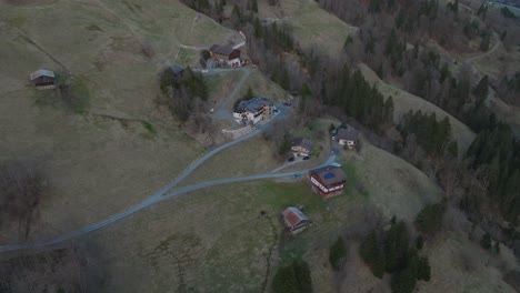 Saalbach-Hinterglemm-ski-resort-with-scattered-chalets-at-dusk,-aerial-view