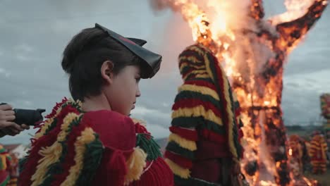 Child-observes-traditional-carnival-bonfire-in-Podence,-Portugal
