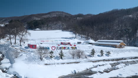Snow-covered-grounds,-Daegwallyeong-Sky-Ranch,-Korea,-panning-establishing-view