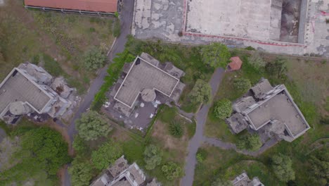 Aerial-top-down-ascending-rotation-shot-of-the-abandoned-unfinished-luxury-hotel-resort-near-Catania,-Sicily,-Italy