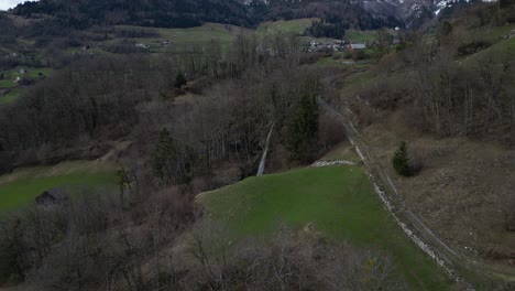 Aerial-view-of-a-small-waterfall-on-high-lands-of-Walensee,-Switzerland