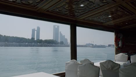 Rascacielos-De-Abu-Dhabi-Y-El-Paseo-Marítimo,-Vista-Desde-Un-Barco-Navegando-En-El-Golfo-Pérsico