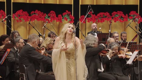 female-opera-singer-on-stage-with-orchestra-symphonic-band,-ensemble-performing-Italian-opera-at-sun-yet-sen-Memorial-Hall