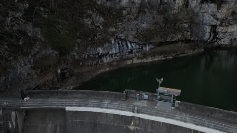 Backward-drone-shot-of-old-dam-in-Walensee,-Switzerland