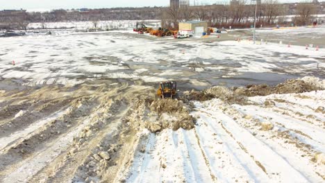 Shovel-dozer-working-on-snow-pile-aftermath-Snowstorm-in-Montréal,-Canada