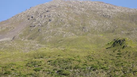 Tilt-up-shot-from-a-trekking-group-toward-to-Pico-Moutain-in-Azores-Archipelago