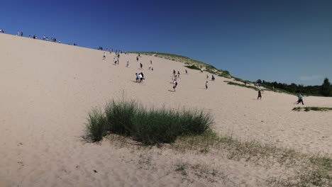 Sleeping-Bear-Sand-Dunes-National-Lakeshore-dune-climb-with-people-walking-on-the-dunes-and-video-panning-right-to-left