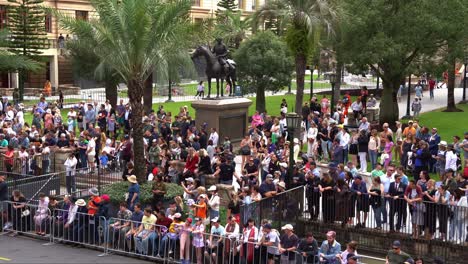 Massive-crowds-of-people-in-Brisbane-lined-up-along-Adelaide-Street,-patiently-waiting-for-the-commencement-of-traditional-Anzac-Day-parade-at-Anzac-Square,-Brisbane-CBD