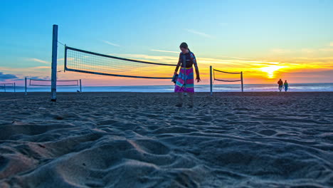 Time-Lapse,-Sunset-Above-Beach-Volleyball-Nets,-Sand-and-Pacific-Ocean-Horizon