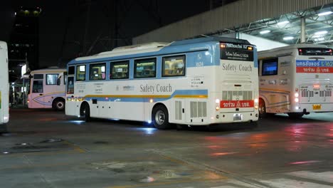 Buses-taking-turns-as-they-park-at-a-busy-bus-terminal-while-passengers-are-passing-by-on-their-way-to-their-platform