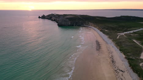 Downward-Lateral-Aerial-View-of-Empty-Sandy-Beach-and-Ocean