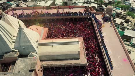 AERIAL-DRONE-VIEW-Don-is-walking-from-the-camera-to-the-side-where-lots-of-people-are-dancing-and-having-fun