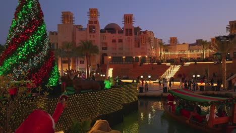 Pan-shot-of-a-Christmas-tree-and-a-boat-at-Souk-Madinat-Jumeirah-in-Dubai