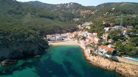 Sa-Riera,-nestled-on-the-Costa-Brava's-coastline,-beckons-visitors-with-its-luxurious-amenities-and-traditional-fishing-village-ambiance